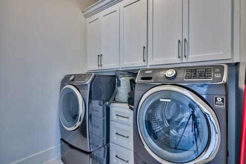 Laundry room has steamer, iron, and all essentials.