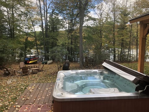 Enjoy lake from our private hot tub. Empty lot on left side & hemlocks on right.
