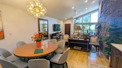 BC West Condo #31 living room with dining table and wood fireplace
