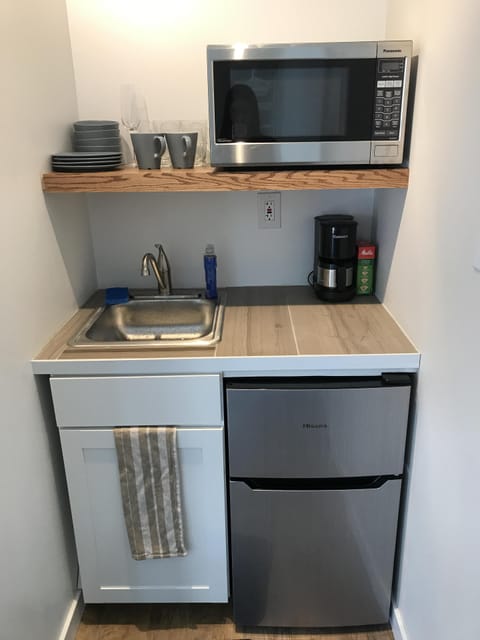 Fridge, microwave, coffee/tea maker, coffee grinder