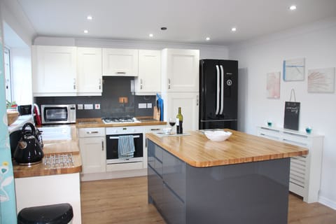 Spacious kitchen with island and breakfast bar .