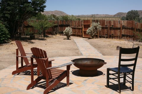 Spacious back yard with wood burning fire pit.