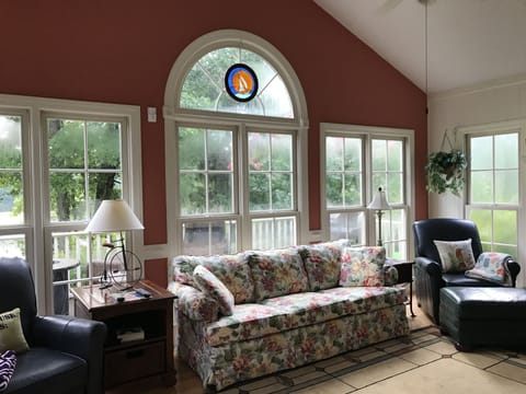 Beautiful sun room overlooking deck and the lake. 