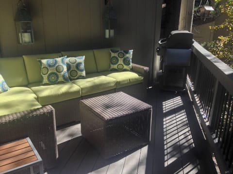 Deck has a BBQ, lounge sofa and lake views.