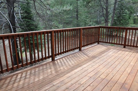 The back patio with a view of the forested backyard, ideal for stargazing
