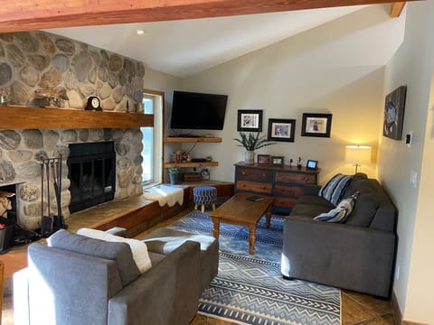 Cozy living area with wood burning fireplace and comfortable queen plus pullout.