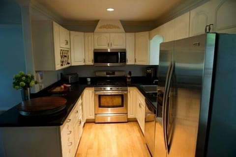 Updated kitchen with stainless steel appliances and black granite counter tops