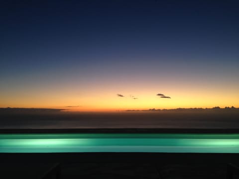 A heated pool, sun loungers