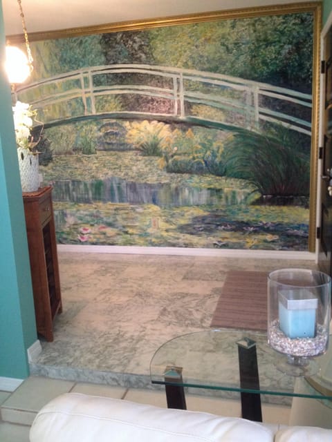 Looking from living room to entryway and wall mural