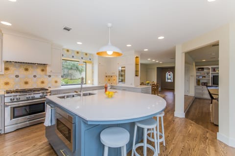 Large island in newly remodeled kitchen, wine fridge, great for gathering.