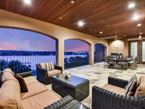 UPSTAIRS PATIO SHOWING SEATING AREA TABLE AND GRILL