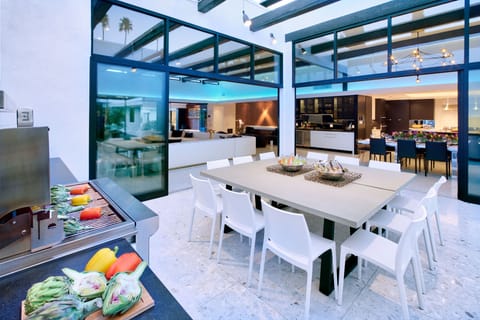 Outdoor dining/kitchen courtyard. Seats up to 16. Heater for chilly nights. Glass walls provide circular flow to great room and kitchen.