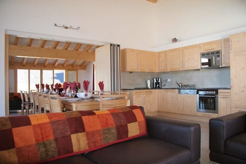 Living room with one of the sofa areas & kitchens