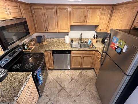 Kitchen with granite countertops and stainless steel appliances 