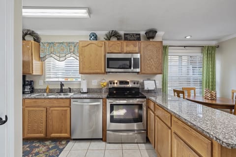 Fully stocked kitchen with stainless appliances and granite countertops