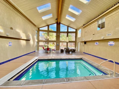 Indoor pool area with vaulted ceilings and skylights