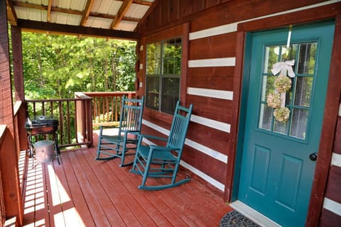 Rocking chairs and charcoal grill on the covered balcony.  