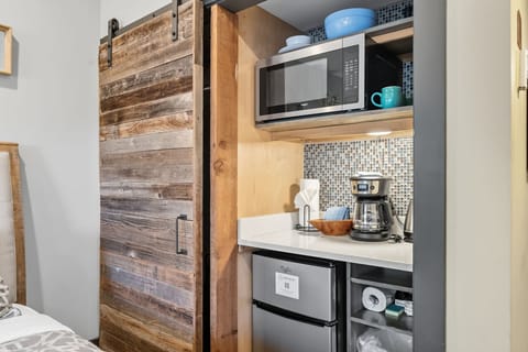 Closet and kitchenette with microwave, coffee maker and mini fridge