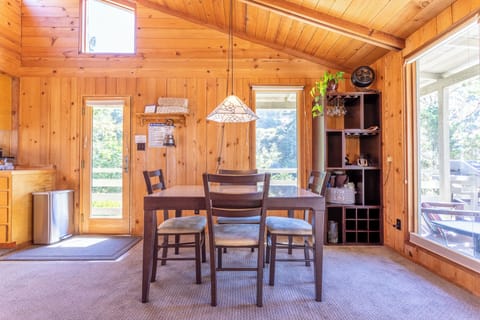 Indoor dining area with a door to the deck.