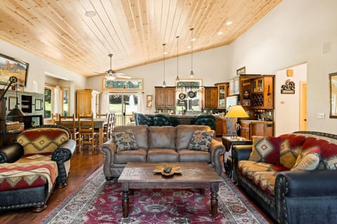 Living Room w/ Wood Burning Fireplace & Lake Views Off of Front Deck