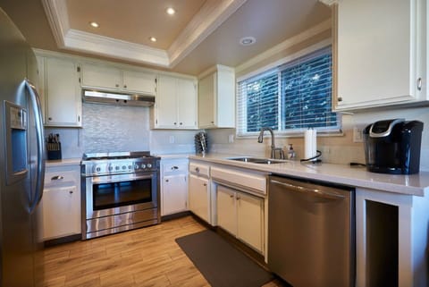 Kitchen with professional grade stove and oven, dishwasher and Keurig.
