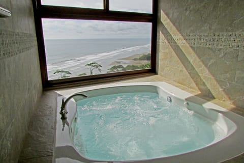 Private Jacuzzi with picture window view in the Honeymoon Sunset Suite
