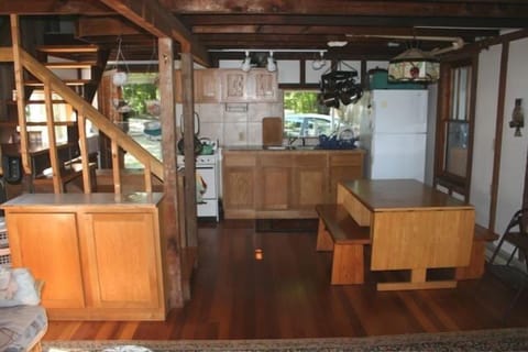 Twin Pines' kitchen features oak cabinets and a fold-down wooden table.