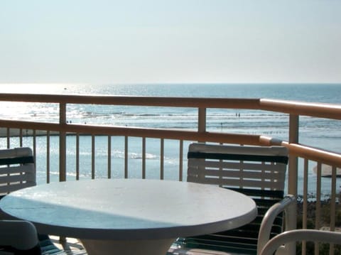 Condo balcony overlooks ocean, tidal creek and miles of undeveloped beach.