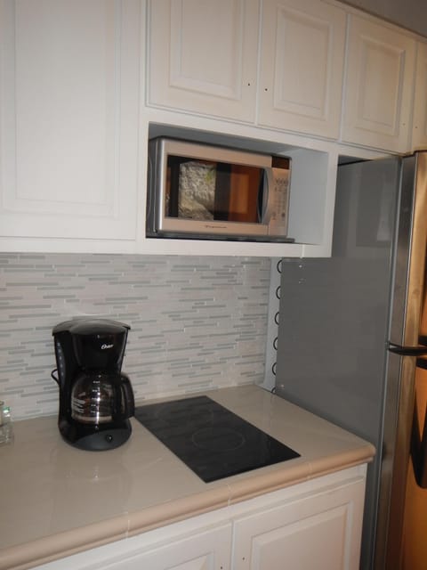 Fridge, microwave, stovetop, coffee/tea maker