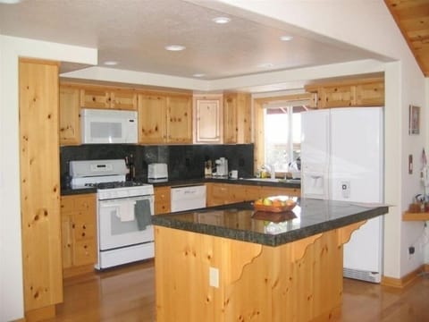 Spacious Gourmet Kitchen. stocked with range of cookware and spices.