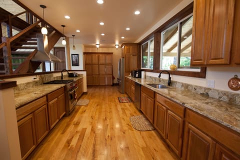 Galley style kitchen features lots of counter space with gas range & two sinks!