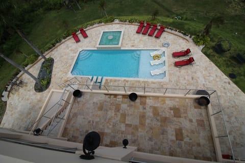 view of pool level and mid level patio from top level terrace