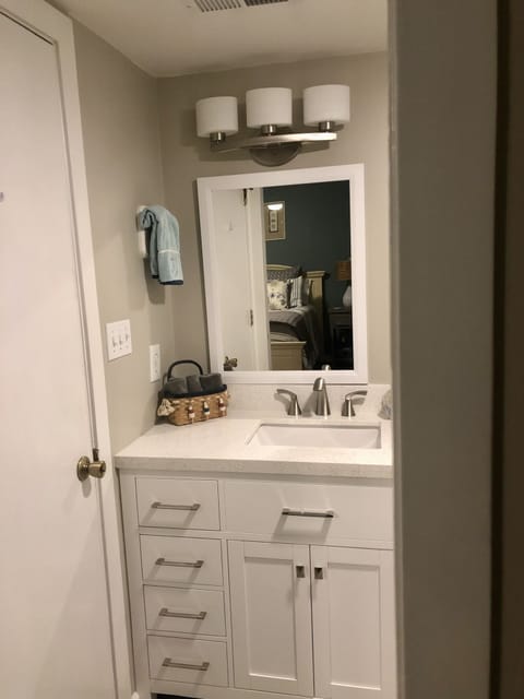 All new fixtures. Offset sink creates more space on vanity top.