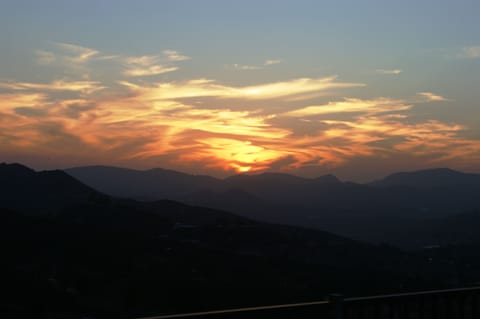 View from the back patio, sunroom, deck, game room and 3 bedrooms at sunset.