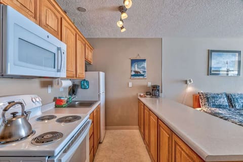 It has a full kitchen with full-size appliances including a stove, oven, microwave, and fridge