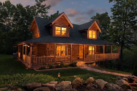 Front view of cabin at dusk. 
