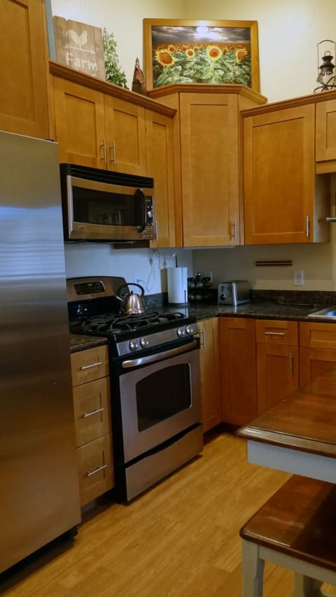 Kitchen is stocked with basic amenities and cooking supplies.