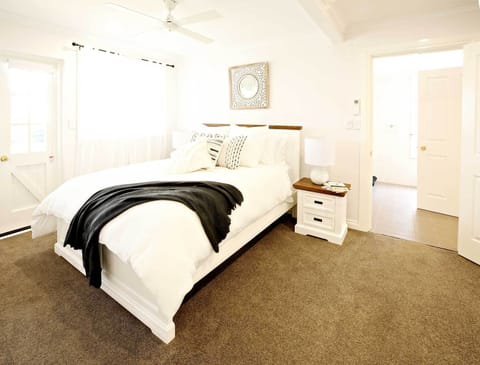 The queen bedroom is luxuriously appointed with premium linens
