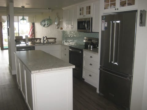 All new kitchen with sea glass backsplash and island for entertaining