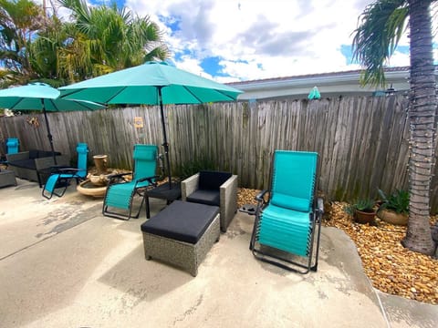 Relax on one of the chaise lounges under a sunbrella.