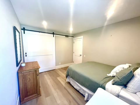 A networked printer is stored in the large closet with barn-style door.