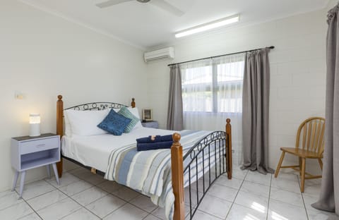 Comfy queen bed in light and airy main bedroom with air-con