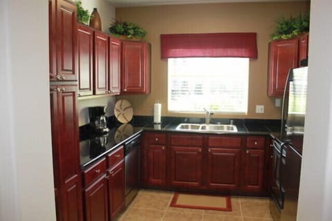 Spacious kitchen with granite counters and stainless appliances.