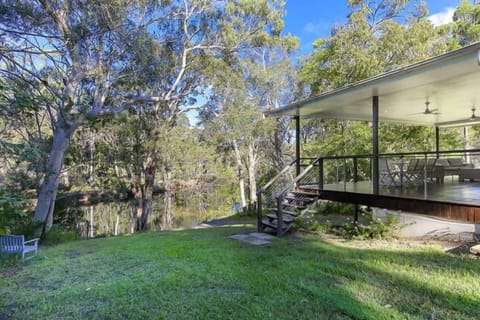 The house revolves around a very large deck in the trees above the river. 