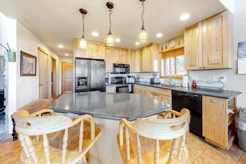 Well appointed kitchen with island and bar stools.