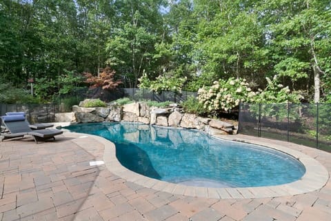 Heated free form gunite saltwater pool (with waterfall) and lush landscaping