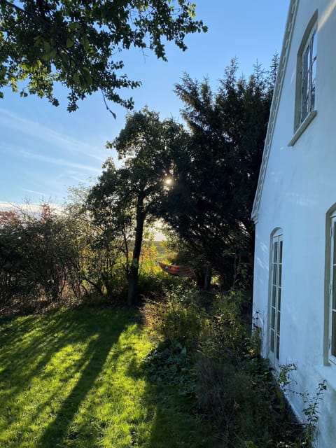 south facade and garden with hammock and fields