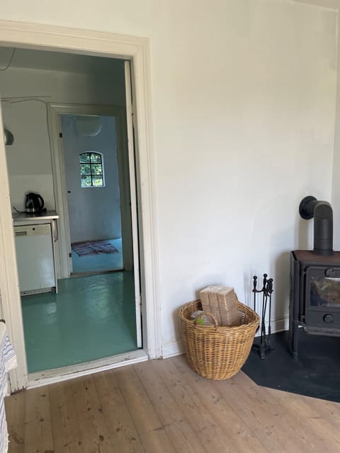 firestove in living area, view towards the kitchen and the entrance (with bathro