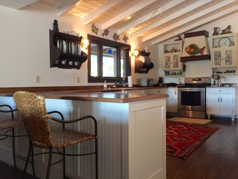 Large kitchen over looking living room with eat in bar seating for 2.