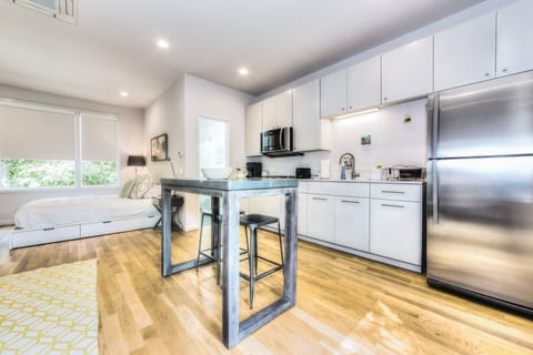 Kitchen and dining table looking to the bathroom and bed